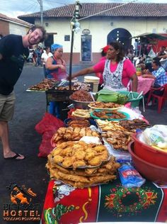 a man standing next to a table filled with food