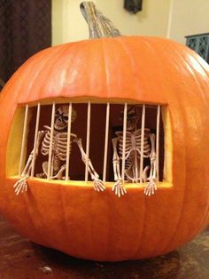 two skeletons in a jail cell carved into a pumpkin