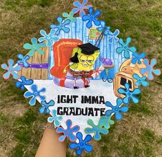 someone holding up a paper cut out of the simpsons character from the animated series, ight imma graduate