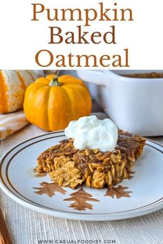 pumpkin baked oatmeal on a plate with whipped cream in the middle and an orange pumpkin behind it