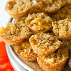 some muffins are sitting on a plate next to other desserts and candies