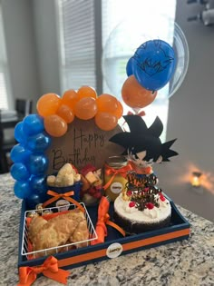 a birthday cake and some balloons on a table