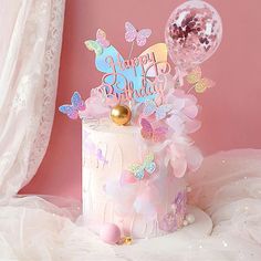 a birthday cake decorated with butterflies and balloons