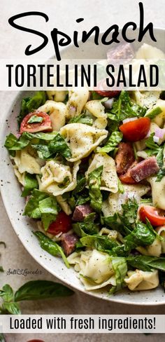 spinach tortellini salad with fresh ingredients in a white bowl