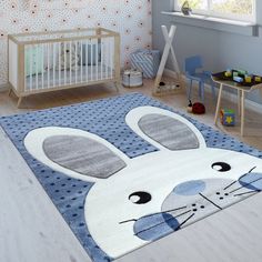 a child's room with a blue rug and white crib in the background