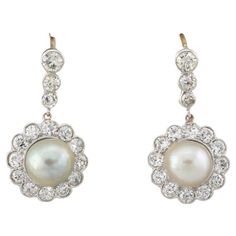 The Classy Must! These gorgeous and timeless antique earrings are Edwardian period They have been hand crafted of solid 18 KT and Platinum – designed in the most elegant cluster design as classy statement of the time Fashioned with a main round drop composed by Diamonds and pearls that sway and dangle from a further line of Diamonds Approx 2.40 Ct of bright white full of dazzling sparkle Diamonds in total rated G/ VVS/SI– Two lustrous sheen antique salt water Pearls of 7.2 mm. make the center of Cluster Design, Water Pearls, Antique Earrings, Pearl Drop Earrings, Sparkle Diamonds, Pearl Drop, Bright White, Antique Jewelry, Diamond Cuts