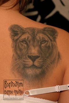 a woman with a lion tattoo on her back