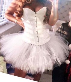 a woman in a white corset taking a selfie