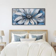 a large white flower on a blue and white background in a bedroom with wicker furniture