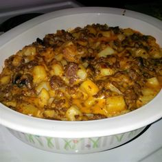 a white bowl filled with food on top of a stove