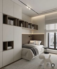 a bedroom with a bed, bookcases and window in the corner next to it