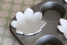 three muffin tins sitting on top of a table next to a cupcake pan