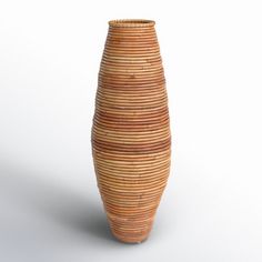 a vase made out of wicker sitting on a white surface with no one around it