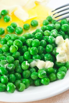 peas and butter on a plate with a fork