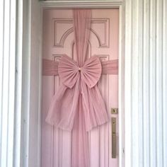 a pink door with a bow on it