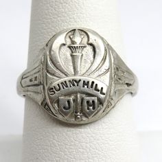 Vintage Sterling silver Class ring Sunny Hill Junior high class of 1943 this ring is a size 8 3/4 this ring is marked sterling and also has a name inscribed on the inner band the ring weighs 6.47 grams the band width at the back of the ring is 3.5mm and the front of the ring is 15.5mm wide PLEASE BE ADVISED PHOTOS ARE CLOSE UPS TO SHOW DETAIL, PLEASE READ DESCRIPTION FOR A BETTER DESCRITION AND UNDERSTANDING OF ITEMS SIZE AND DIMENSIONS.This item is preloved and Vintage. This means it may have s Art Deco Silver Signet Ring With Polished Finish, Silver Art Deco Signet Ring With Polished Finish, Art Deco Silver Signet Ring, Silver Art Deco Signet Ring, Antique Silver Signet Ring For Commemoration, Silver Engraved Ring Stamped 14k For Anniversary, Heirloom Silver Rings For Commemoration, Vintage Sterling Silver Signet Ring For Commemoration, Antique Silver Engraved Ring With Hallmarks