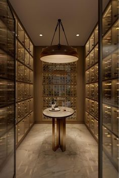 a wine cellar with many bottles on the wall and a round table in front of it