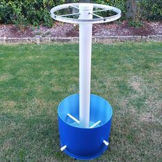 a blue and white water fountain in the grass