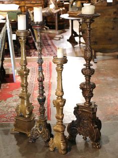 three candles are sitting next to each other on the floor