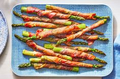 asparagus wrapped in bacon on a blue plate