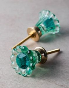 two green and white flower shaped glass knobs