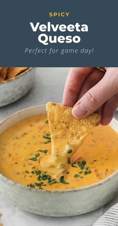 a hand dipping a tortilla chip into a bowl of quesadilla soup