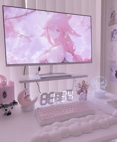 a desk with a clock, keyboard and computer monitor on it in front of a pink background