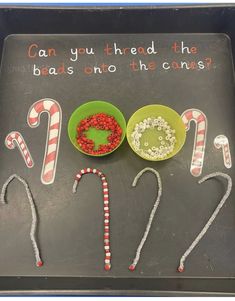 a tray with candy canes and candies on it that says can you thread the beads onto the criss?