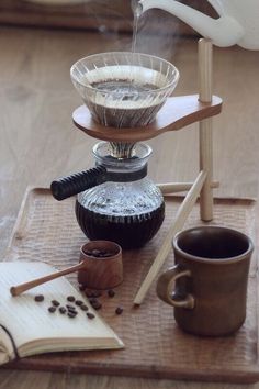 three tiered tray with coffee cups and an open book