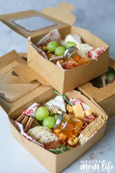 two open boxes filled with different types of snacks and drinks on top of a table