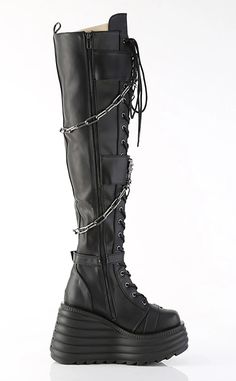 Get ready to dominate the room with the MORTE-215s! These thigh highs boots feature grommet buckle straps and metal skull knockers, be the badass that you are. 4 1/2" (114mm) Wedge Platform Lace-Up Front Thigh-High Boot Featuring 2 Double Grommet Buckle Straps with Metal Skull Knockers at Center and 2 Lower Skull Buckle Straps Skull Knockers on the Outer Heel & Toe Hanging Chain Detail Blacklight Reflective Back Coffin Inside Metal Zip Closure US women's sizing-refer to size chart for more info. Gothic Platform Boots With Grommets, Gothic Leather Knee-high Boots, Gothic Knee-high Moto Boots For Alternative Fashion, Gothic Leather Knee-high Boots For Alternative Fashion, Edgy Knee-high Boots For Streetwear, Leather Punk Platform Boots For Club, Punk Leather Platform Boots For Club, Punk Leather Knee-high Boots For Streetwear, Edgy Boots With Metal Feet For Cosplay