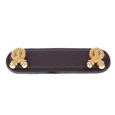 a black leather belt with two gold metal decorations on the front and back ends,