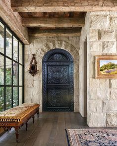 a large wooden door sitting inside of a stone building