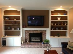 a living room filled with furniture and a flat screen tv mounted on the wall above a fireplace