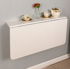 a white radiator with two cups on it