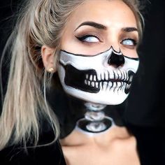 a woman with makeup painted to look like a skeleton