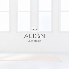 a yoga mat in front of two windows with the word align on it and an image of