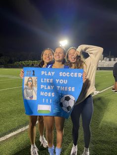 three girls holding up a sign that says play soccer like you play these hoses