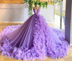 Unleash your inner royalty with this enchanting purple ball gown. This dress is crafted from layers of soft tulle and the voluminous skirt cascades into a graceful sweep train, giving you a majestic silhouette. Sparkling beaded embellishments add a touch of glamour, ensuring you shine with every step. Featuring a flattering V-neckline and a sleeveless design, this dress exudes elegance and charm, perfect for any grand occasion. The lace-up back ensures a tailored fit, combining beauty with comfo Purple Ball Gown, Puffy Prom Dresses, Prom Dress With Train, Pretty Quinceanera Dresses, Tulle Evening Dress, Unique Prom Dresses, Tulle Ball Gown, Ball Gowns Evening, Pretty Prom Dresses