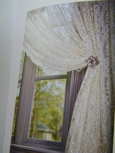 an open window with white lace on it