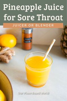 a pineapple juice for sore throat is in a glass next to some oranges