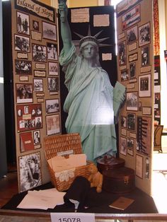 the statue of liberty is surrounded by many pictures and photos on display in a museum