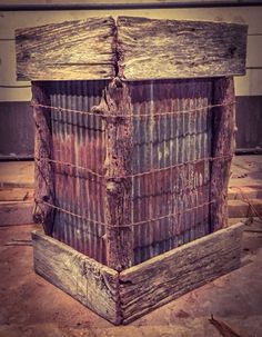 an old wooden box sitting in the middle of a room with peeling paint on it