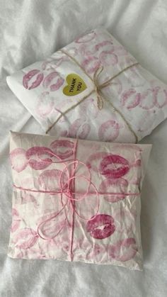 two pillows with pink and white designs on them