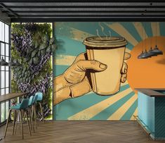 there is a mural on the wall of this restaurant with a hand holding a coffee cup