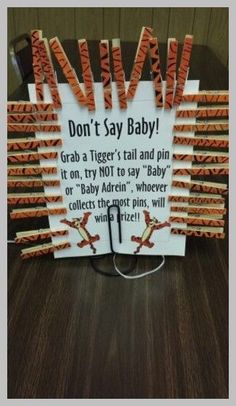 a sign that reads don't say baby grab a tiger's tail and pin it on, try not to say baby or baby