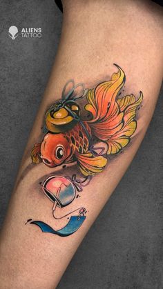 a goldfish tattoo on the leg