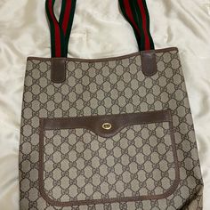 Gucci Tote In Excellent Vintage Condition. Classic Gg Coated Canvas With A Rare Two Toned Interlocking G Logo. The Green And Red Gucci Web Strap Adds Unique Detail. The Inside Is Perfectly Clean. There Is No Dust Or Flaking. The Only Defect Is A Liquid Stain On The Inside Of The Front Flap But Is Not Visible On The Outside Canvas. (See Last Picture) Gucci Lap Top Bag, Gucci Fabric, Gucci Tote Bag, G Logo, Fabric Tote Bags, Gucci Tote, Gucci Monogram, Gucci Bamboo, Fabric Tote