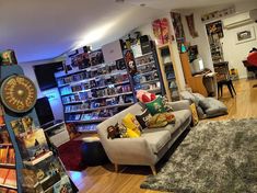 a living room filled with furniture and lots of books