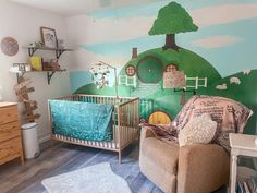 a baby's room with a couch, chair and crib